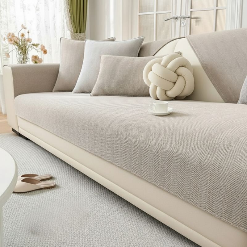 Khaki herringbone chenille sofa cover on white sofa - minimalist living room style