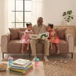 Grandfather reading to two granddaughters on tan herringbone sofa cover - lifestyle shot - kid-proof sofa cover