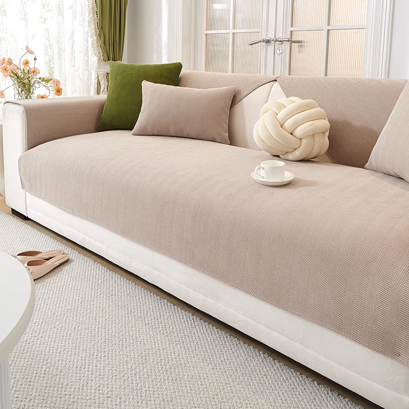 Beige herringbone chenille sofa cover on white sofa - wide angle room view