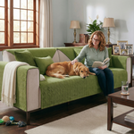 Woman reading with Golden Retriever on olive green herringbone sofa cover - pet owner lifestyle - dog-proof sofa cove