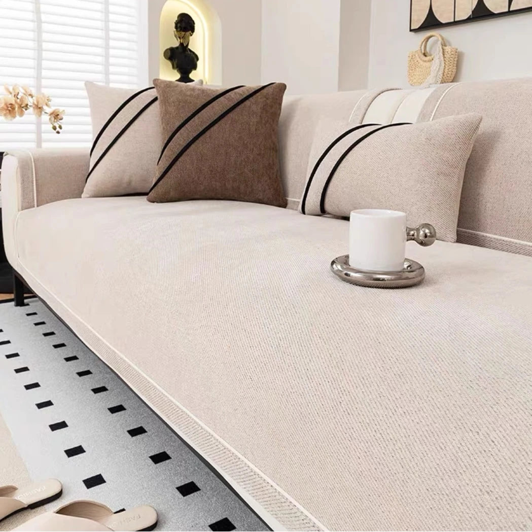 Beige luxurious chenille sofa cover on modern white sofa - minimalist living room sofa protection