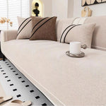 Beige luxurious chenille sofa cover on modern white sofa - minimalist living room sofa protection