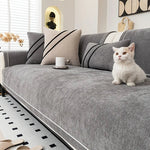White cat sitting on dark gray luxurious chenille sofa cover - stylish sofa cover for cat owners