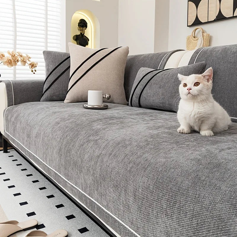 White cat sitting on dark gray luxurious chenille sofa cover - stylish sofa cover for cat owners