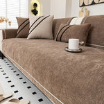 Brown luxurious chenille sofa cover on black-frame sofa - warm toned living room - premium sofa cover