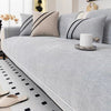 Light gray luxurious chenille sofa cover close-up on black-frame sofa - soft non-slip sofa cover