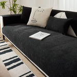 Black Morandi chenille sofa cover on sofa with beige abstract face cushion and book